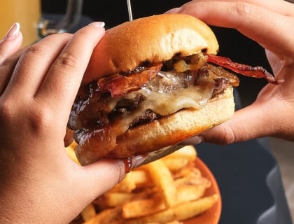 Hands holding a burger