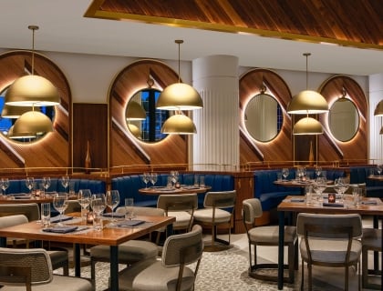 dining area with blue booths and wooden walls
