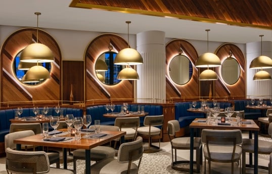 dining area with blue booths and wooden walls