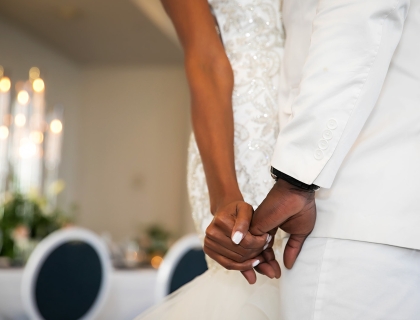 a bride and groom holding hands