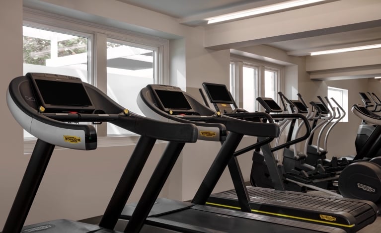 workout machines in the front of some windows