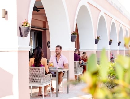 various groups of people eating outside on a restaurant patio