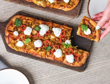 Pizza on a serving board on a table
