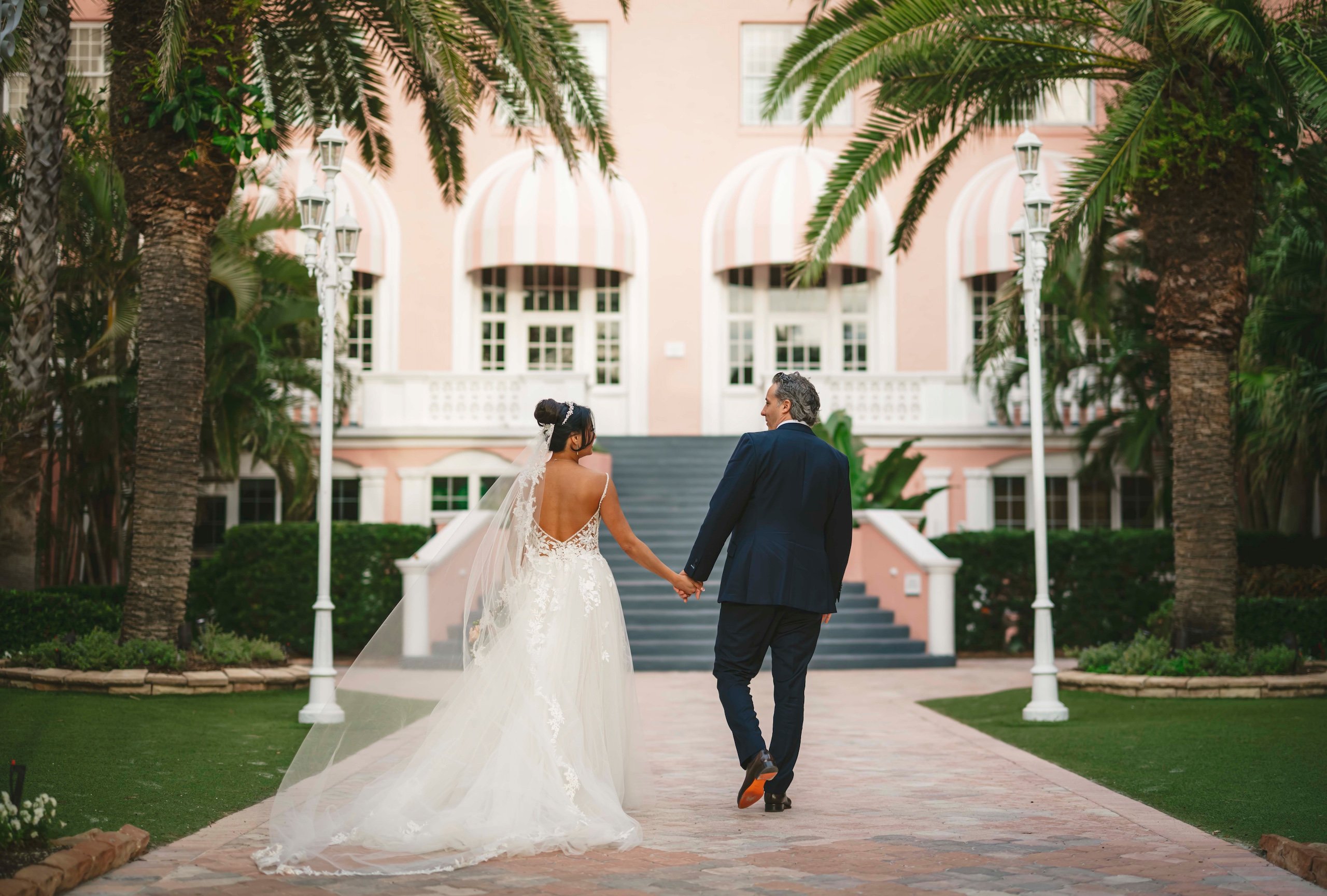 bride and groom walking through the courtyard